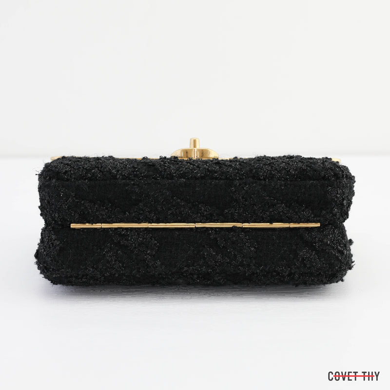 CHANEL, Quilted black leather and gold metal clutch bag …
